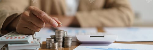 Preview: Stacking Coins on a Desk with Financials