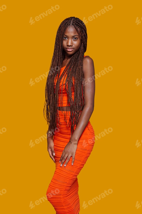 Preview: Fashion model wearing an orange outfit and long braids
