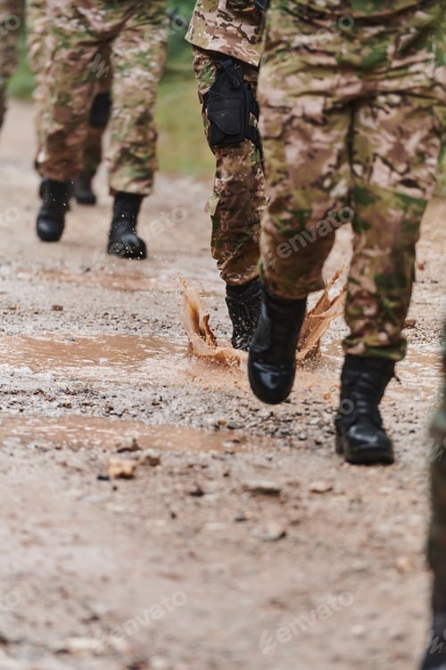 Preview: Close up photo, the resilient legs of elite soldiers, clad in camouflage boots, stride purposefully