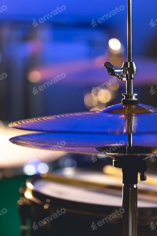 Preview: Drum cymbal close-up on a dark blurred background.