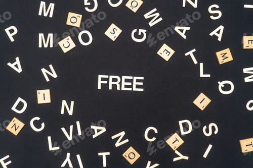 Preview: FREE word written on dark paper background. FREE text for your concepts
