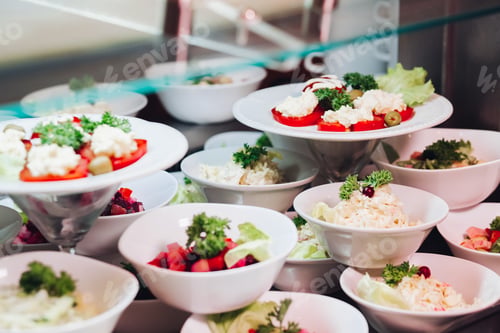 Preview: Many round plates with tasty vegetables dish of salads in restaurant