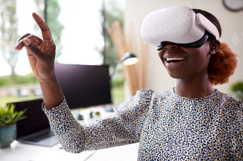 Preview: Woman Working From Home Office Sitting At Desk Wearing VR Headset Interacting With AR Technology