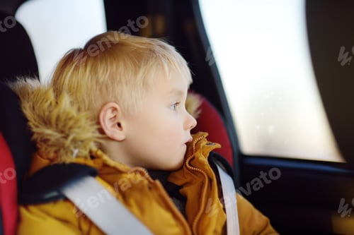 Preview: Child Looking Out Car Window on Road Trip