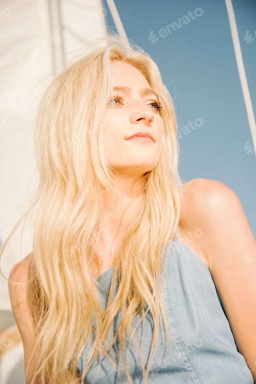 Preview: Young blond woman on a sail boat.