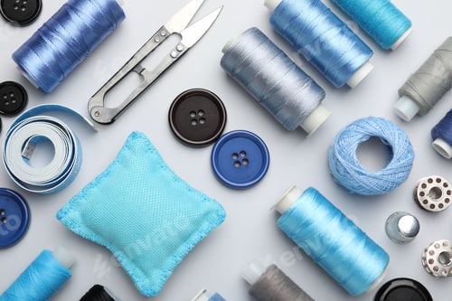 Preview: Different sewing supplies on light grey background, flat lay