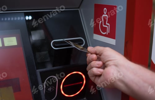 Preview: Woman hand inserting ATM credit card into bank machine to transfer money or withdraw