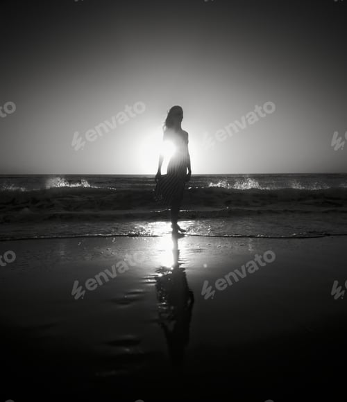 Preview: Sunset and beach silhouette shot with reflection in the water