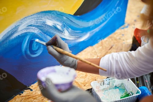 Preview: Female artist hand applies small brushstrokes of paint with paintbrush to canvas creating picture