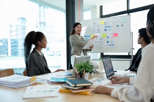 Preview: diverse business team people and female leader boss discuss financial result review paperwork share