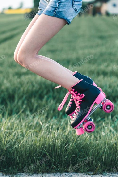 Preview: Teenage girl having fun rollerskating, jumping, spending time outdoors