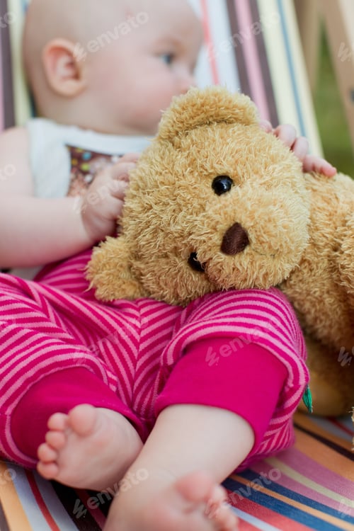 Preview: Baby girl holding teddy bear