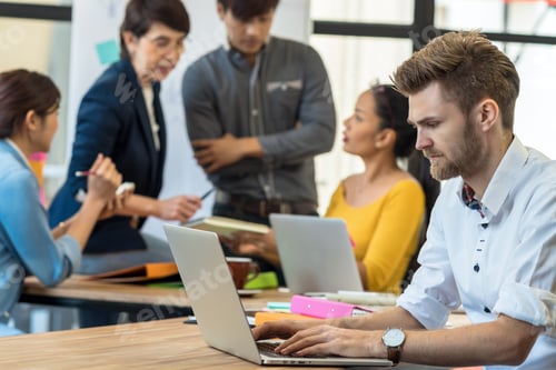 Preview: Businessman working in serious action with computer