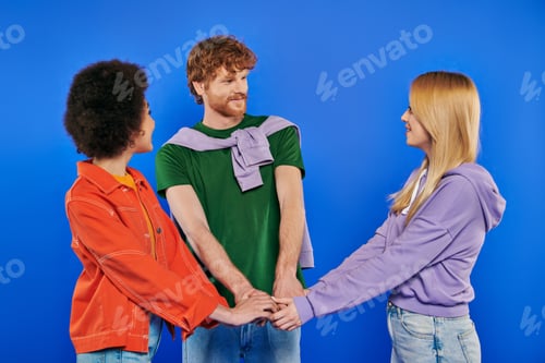 Preview: polyamorous relationship concept, polygamy people, young man and multicultural women holding hands