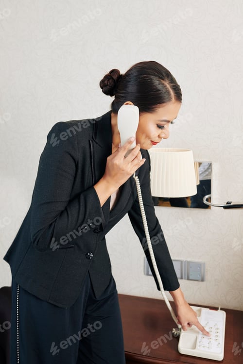 Preview: Woman Making Phone Call From Hotel Room