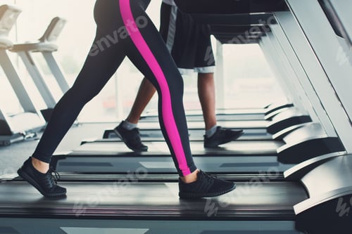 Preview: Woman's legs on treadmill in fitness club, healthy lifestyle