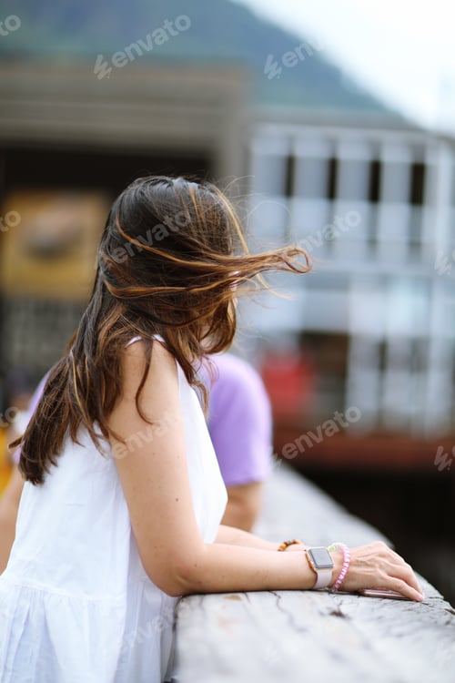 Preview: Wind blew the hair of a woman while looked at nature view at mountainside closeup background