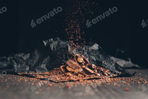 Preview: Falling pieces of shredded chocolate on a pile on a table