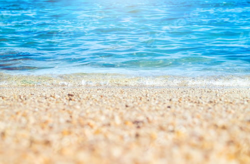 Preview: Close up wave of blue sea on sand beach seashore