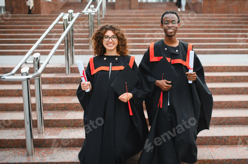 Preview: Diverse students celebrating graduation success on university stairs