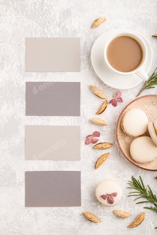 Preview: Gray business card mockup with cup of coffee, almonds and macaroons on gray concrete