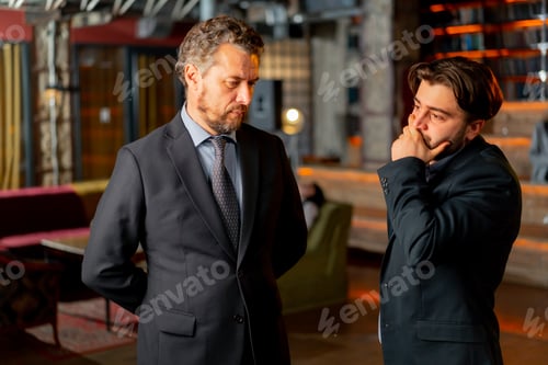 Preview: director and employee are standing and discussing the current problem solution of the problem