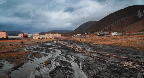 Preview: Abandoned settlement in Pyramiden Svalbard surrounded by mountains under cloudy sky