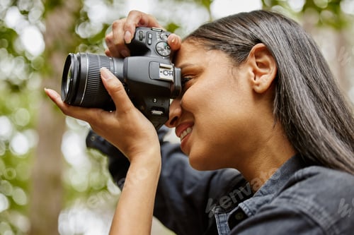 Preview: Cropped shot of an attractive young woman taking photographs while hiking in the wilderness