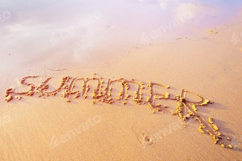 Preview: Summer letters handwritten in sand on beach