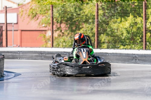 Preview: African woman driving go kart on racing track