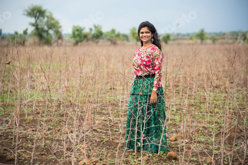Preview: Beautiful young girl wear traditional dress in the field.