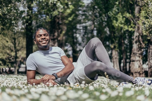Preview: African american gay young man in a flowered park