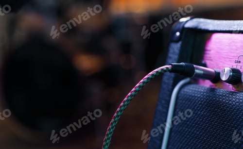 Preview: Part of guitar amp with plug in cable. Music concert or recording concept. Copy space