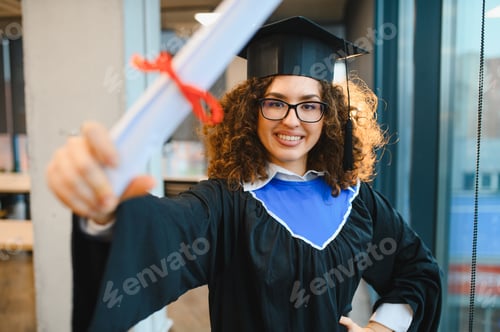 Preview: Female graduate student holding university diploma celebrating success
