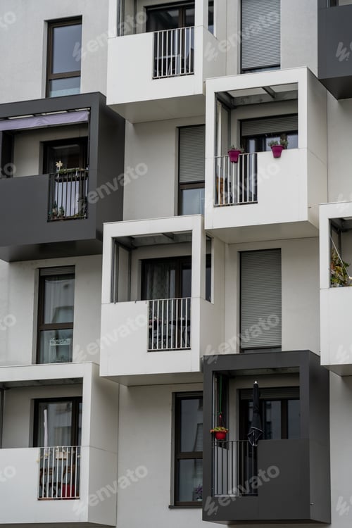 Preview: Multi-unit residential building with balconies, located in a vibrant city street