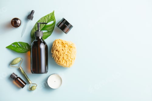 Preview: Natural skin care products on blue background, flat lay.