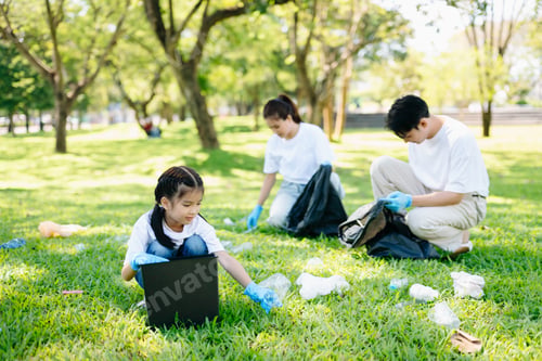 Preview: Joyful family volunteering to clean up a green park together. A positive lifestyle scene promoting