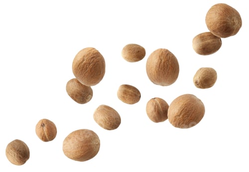 Preview: Aromatic nutmeg seeds falling on white background
