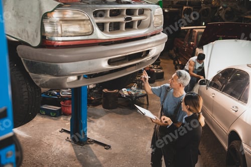 Preview: customer making inspection check to a car engine repair occupation job at garage service