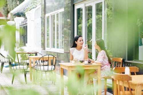 Preview: Young women at cafe table