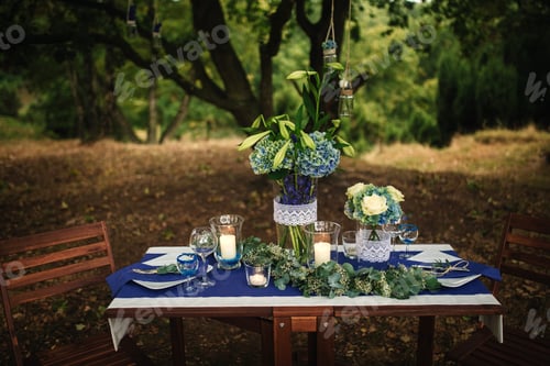 Preview: Decor. Details. Wedding decorations. On the wooden table in the woods there is a flower arrangement