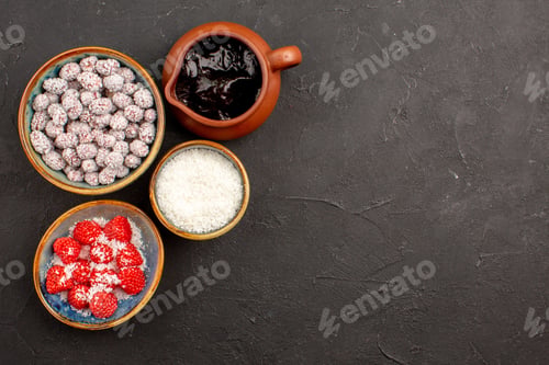 Preview: top view different candies with chocolate syrup on dark background color candy tea biscuit