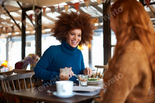 Preview: Woman dining in cafe with friend, smiling