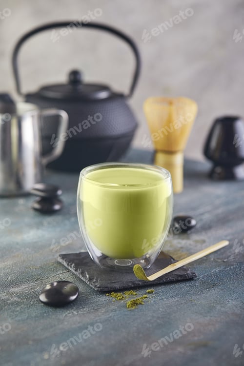 Preview: Matcha green tea on a blue-gray background. Match tea with a chapel and a bamboo spoon