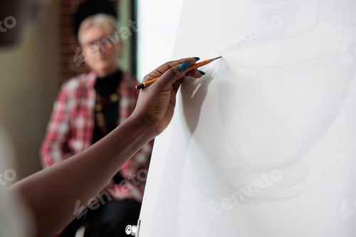 Vista previa: Close up of creative student sketching vase model on canvas