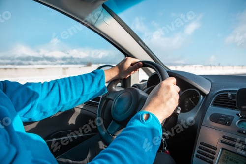 Preview: man hands on steering wheel winter road trip