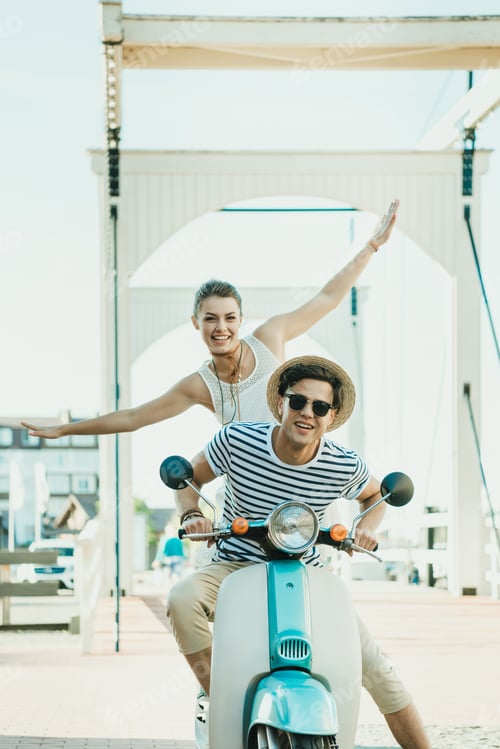 Preview: happy couple in love riding retro scooter together