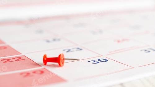 Preview: Red thumbtack on a calendar page.