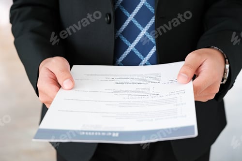 Preview: Close-Up of Businessman Holding a Resume.