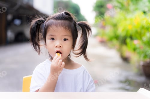 Preview: Cute little girl bunches hair and eating oranges into her mouth.